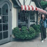 Woman walking through European-esque streets of Carmel, CA